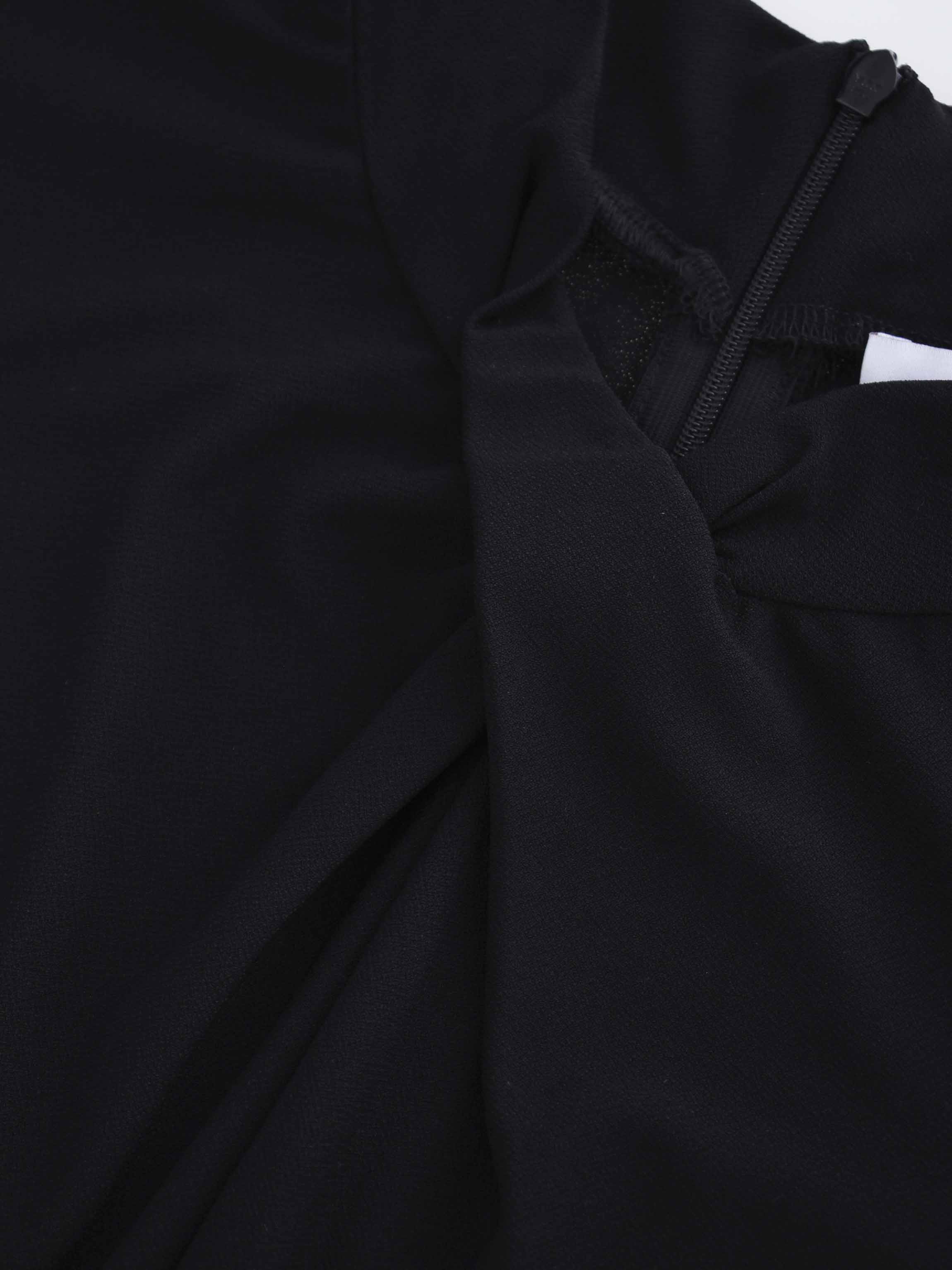 Close-up of a black garment with a textured fabric texture.