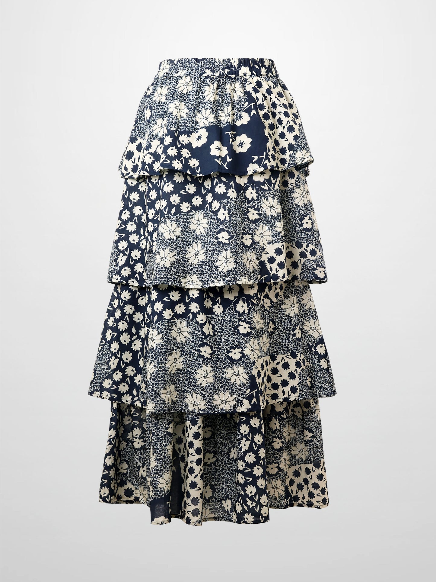 Layered floral skirt with blue and white pattern on a light gray background