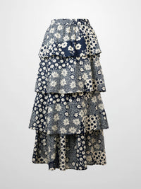 Layered floral skirt with blue and white pattern on a light gray background
