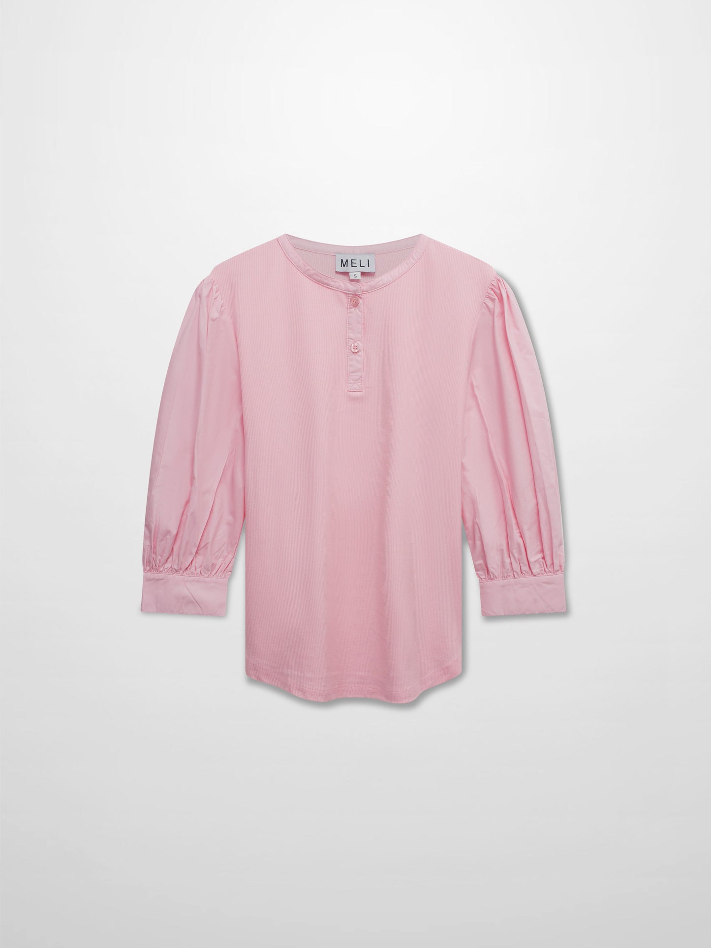 Pink blouse with long sleeves on a light gray background