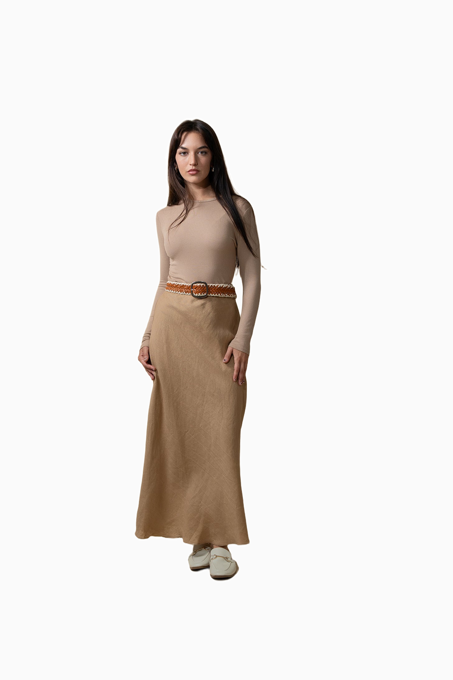 Woman wearing a beige dress with a belt on a white background