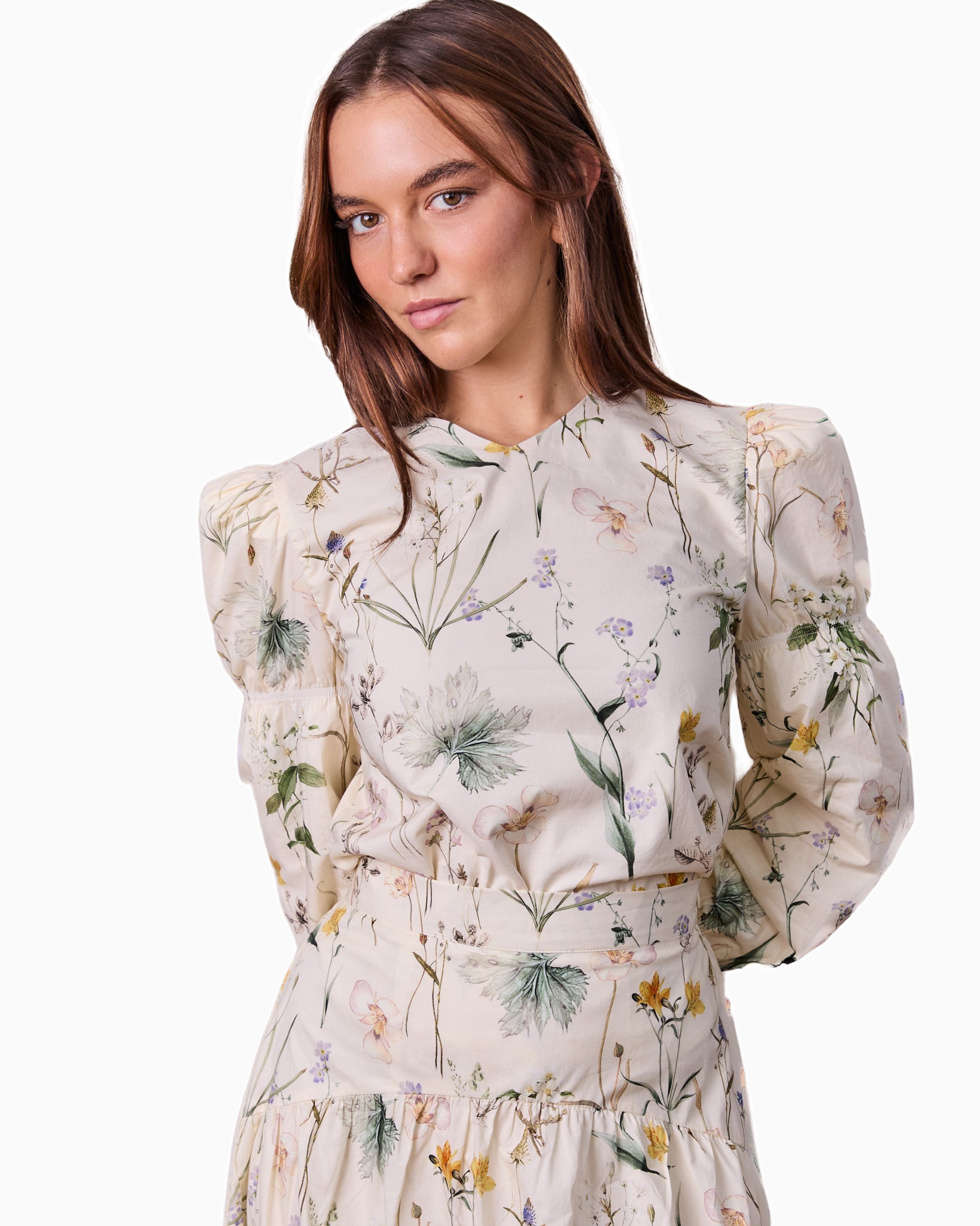 Woman wearing a floral dress on a white background