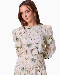 Woman wearing a floral dress on a white background