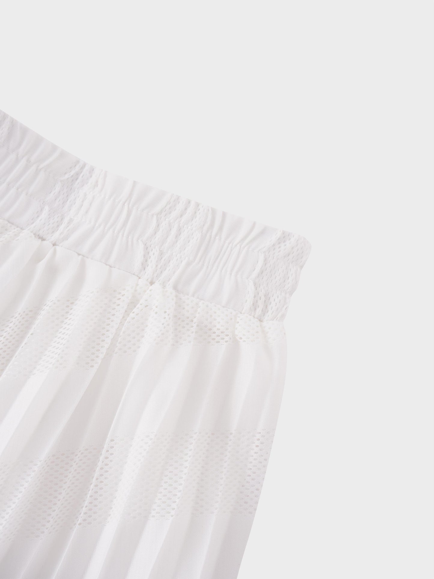 Close-up of a white textured fabric with a light gray background