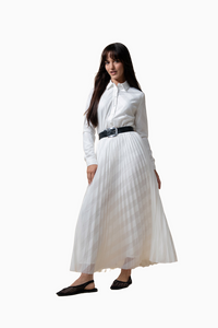 Woman wearing a white dress with a black belt on a white background
